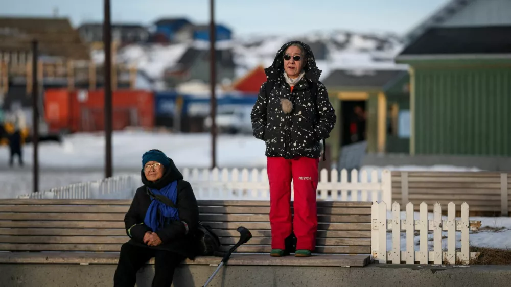 A person stands on a bench in Nuuk, Greenland, January 23, 2026. REUTERS/Marko Djurica