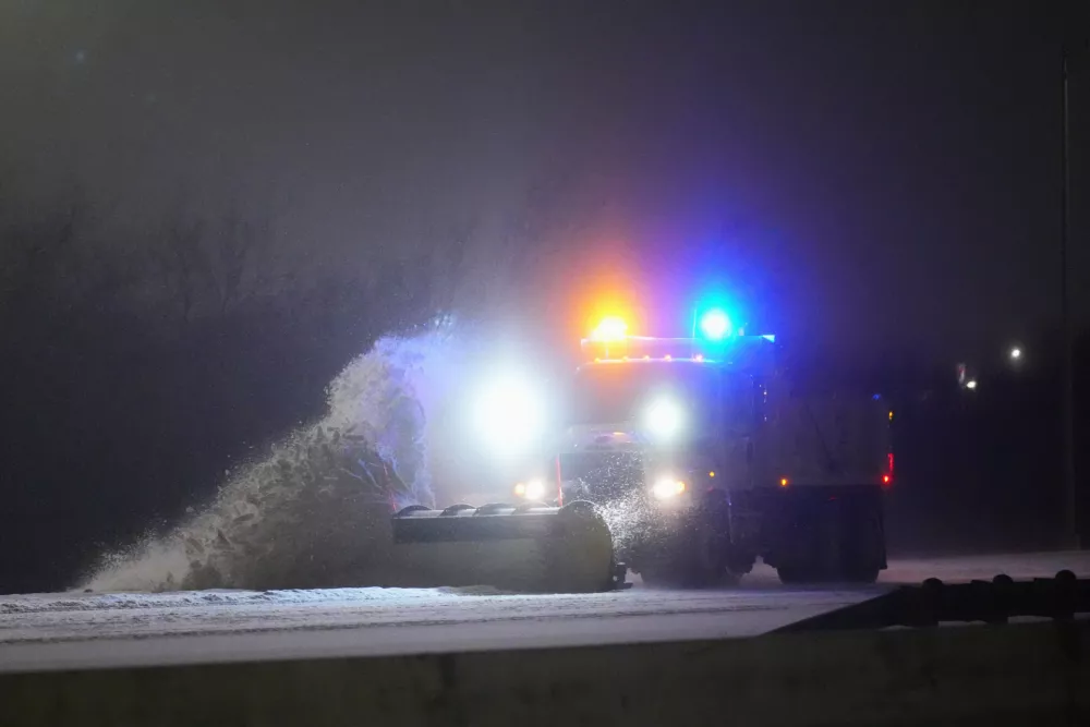 A truck plows the eastbound lanes of Interstate-20 during a snow storm Saturday, Jan. 24, 2026, in Grand Prairie, Texas. (AP Photo/Julio Cortez)