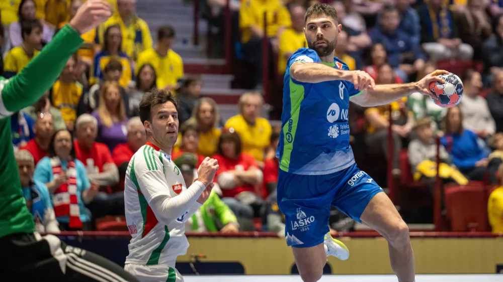 Slovenia's Blaž Janc, right, in action during the 2026 EHF European Men's Handball Championship main round match between Slovenia and Hungary at Malmo Arena, in Malmo, Sweden, Sunday, Jan. 25, 2026. (Johan Nilsson/TT via AP)
