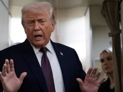 FILE PHOTO: U.S. President Donald Trump speaks to reporters over the North Atlantic as he returns to Washington from the World Economic Forum in Davos, Switzerland, aboard Air Force One, U.S., January 22, 2026. REUTERS/Jonathan Ernst/File Photo