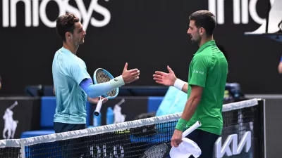 28 January 2026, Australia, Melbourne: Lorenzo Musetti of Italy retires injured during his men's quarterfinals against Novak Djokovic of Serbia on day 11 of the 2026 Australian Open tennis tournament at Melbourne Park in Melbourne. Photo: Joel Carrett/AAP/dpa
