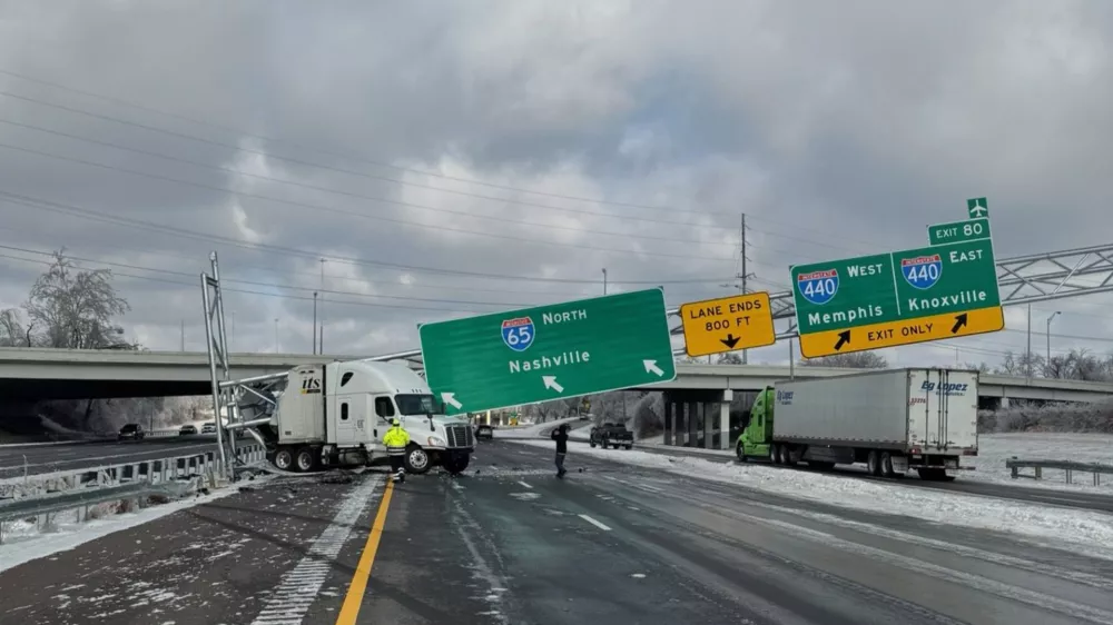 This photo provided by Metropolitan Nashville Police Department shows the wreckage of a tractor trailer under a fallen road sign along an icy highway Monday, Jan. 26, 2026, in Nashville, Tenn. (Metropolitan Nashville Police Department via AP)