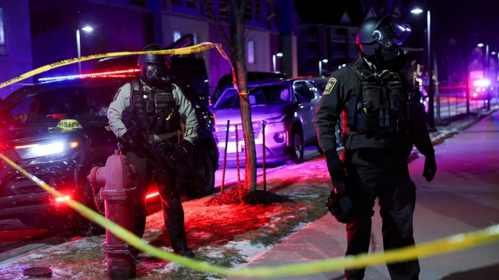 Law enforcement officers stand guard around a hotel where Greg Bovino, who has been removed from his role as the "commander at large" for the U.S. Border Patrol, is reportedly staying, in Maple Grove, Minnesota, U.S., January 26, 2026. REUTERS/Shannon Stapleton REFILE - CORRECTING LOCATION FROM "MINNEAPOLIS" TO "MAPLE GROVE".