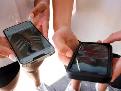 FILE - Young people use their phones to view social media in Sydney, Nov. 8, 2024. (AP Photo/Rick Rycroft, File)
