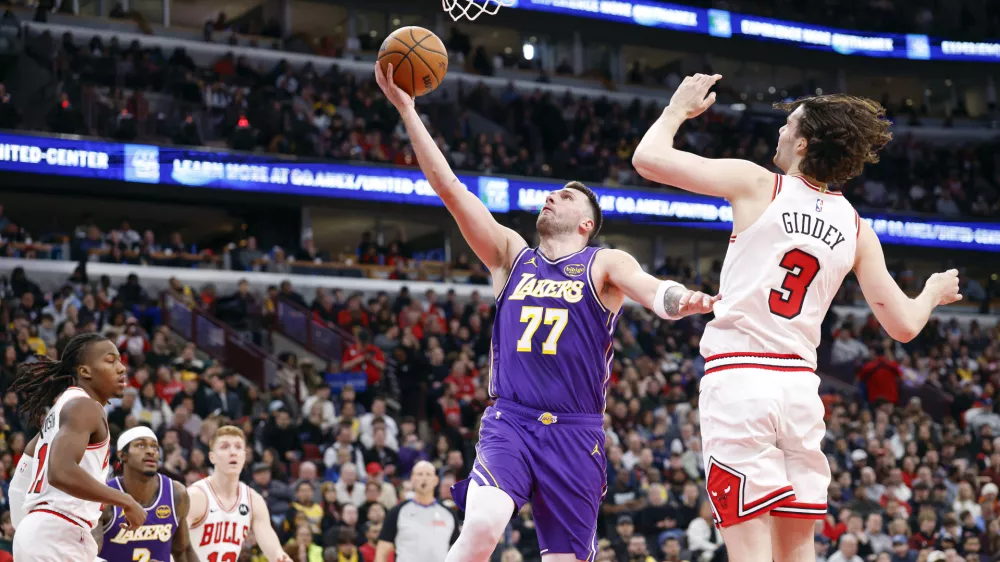 Jan 26, 2026; Chicago, Illinois, USA; Los Angeles Lakers guard Luka Doncic (77) goes to the basket against Chicago Bulls guard Josh Giddey (3) during the second half at United Center. Mandatory Credit: Kamil Krzaczynski-Imagn Images