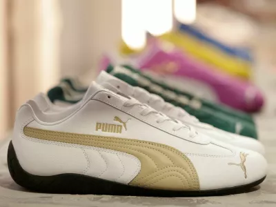 FILE PHOTO: Puma Speedcat OG sneakers are displayed at the Puma Mostro House in Paris, France, January 24, 2025. REUTERS/Abdul Saboor/File Photo