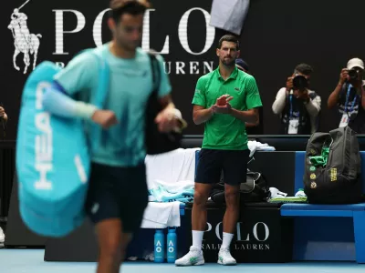 Tennis - Australian Open - Melbourne Park, Melbourne, Australia - January 28, 2026 Serbia's Novak Djokovic applauds for Italy's Lorenzo Musetti after he retires from their quarter final match REUTERS/Hollie Adams