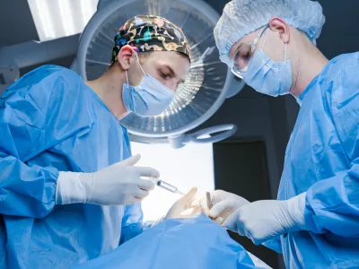 Anesthesia thigh injection before Buccal fat removal. Bisha lumps removal. Plastic surgery in clinic. Surgery operation for modifying the eye region of the face in medical clinic.