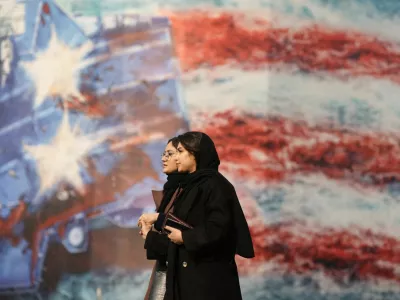 People walk past an anti-U.S. billboard in Tehran, Iran, January 26, 2026. Majid Asgaripour/WANA (West Asia News Agency) via REUTERS ATTENTION EDITORS - THIS PICTURE WAS PROVIDED BY A THIRD PARTY   TPX IMAGES OF THE DAY