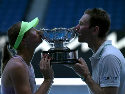 Tennis - Australian Open - Melbourne Park, Melbourne, Australia - January 30, 2026 Australia's Olivia Gadecki and Australia's John Peers pose with the trophy after winning their mixed doubles final REUTERS/Jaimi Joy