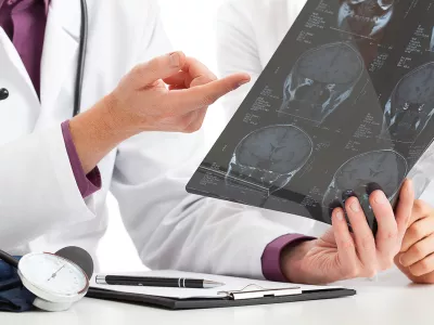 Physician looking at x-ray and debating about results