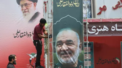 A man installs a banner with a picture of late Islamic Revolutionary Guard Corps (IRGC) Commander-in-Chief Major General Hossein Salami, following the Israeli strikes on Iran, in Tehran, June 14, 2025. Majid Asgaripour/WANA (West Asia News Agency) via REUTERS  ATTENTION EDITORS - THIS PICTURE WAS PROVIDED BY A THIRD PARTY.   TPX IMAGES OF THE DAY