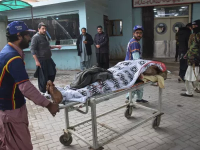 Volunteers transport a body of a police officer who was killed in a militants attack, at a hospital in Quetta, Pakistan, Saturday, Jan. 31, 2026. (AP Photo/Arshad Butt)