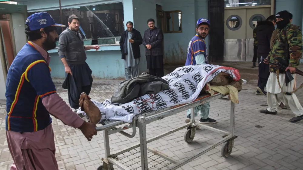 Volunteers transport a body of a police officer who was killed in a militants attack, at a hospital in Quetta, Pakistan, Saturday, Jan. 31, 2026. (AP Photo/Arshad Butt)