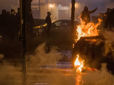 SENSITIVE MATERIAL. THIS IMAGE MAY OFFEND OR DISTURB A demonstrator gestures behind a burning refuse container as demonstrators clash with police following a march in support of Askatasuna, a left-wing social centre that was evicted by authorities in Turin, Italy, January 31, 2026. REUTERS/Michele Lapini