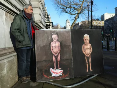 Artist Kaya Mar stands next to his satirical paintings depicting nude figures of British Prime Minister Keir Starmer and Andrew Mountbatten‑Windsor, the younger brother of Britain's King Charles, formerly Prince Andrew, Duke of York, as pressure builds on him to give evidence following the release of new U.S. Justice Department records linked to the late financier and convicted sex offender Jeffrey Epstein, titled "Mandy" and "Andy," on Downing Street in London, Britain, February 4, 2026. REUTERS/Toby Melville