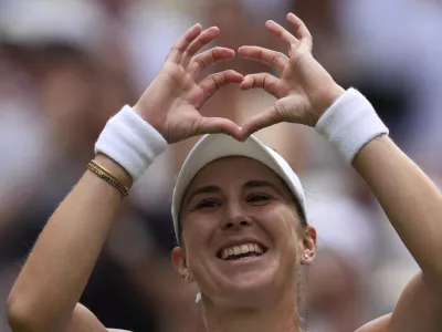 Switzerland's Belinda Bencic celebrates after beating Mirra Andreeva of Russia in a quarterfinal women's singles match between at the Wimbledon Tennis Championships in London, Wednesday, July 9, 2025. (AP Photo/Kin Cheung)