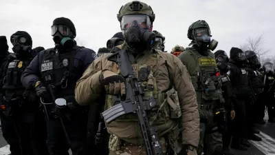 Members of U.S. Customs and Border Protection (CBP) and other law enforcement officials stand guard, in front of the Bishop Henry Whipple Federal Building, during a protest more than a week after an ICE agent fatally shot Renee Nicole Good, in Minneapolis, Minnesota, U.S., January 17, 2026. REUTERS/Seth Herald TPX IMAGES OF THE DAY