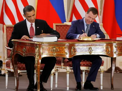 FILE PHOTO: Barack Obama (L) and Dmitry Medvedev, who were then the U.S. and Russian presidents, sign the new Strategic Arms Reduction Treaty (START II) at Prague Castle in Prague April 8, 2010.   REUTERS/Jason Reed/File Photo