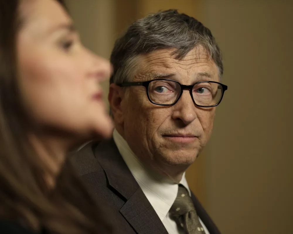 Bill Gates listens to his wife Melinda Gates during an interview in New York, Wednesday, Jan. 21, 2015. As the world decides on the most crucial goals for the next 15 years in defeating poverty, disease and hunger, the $42 billion Gates Foundation announces its own ambitious agenda. (AP Photo/Seth Wenig)