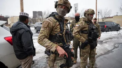 Federal agents stand next to a man they approached during immigration enforcement action the day after the fatal shooting of Renee Nicole Good by a U.S. Immigration and Customs Enforcement (ICE) agent, in Minneapolis, Minnesota, U.S., January 8, 2026. REUTERS/Tim Evans