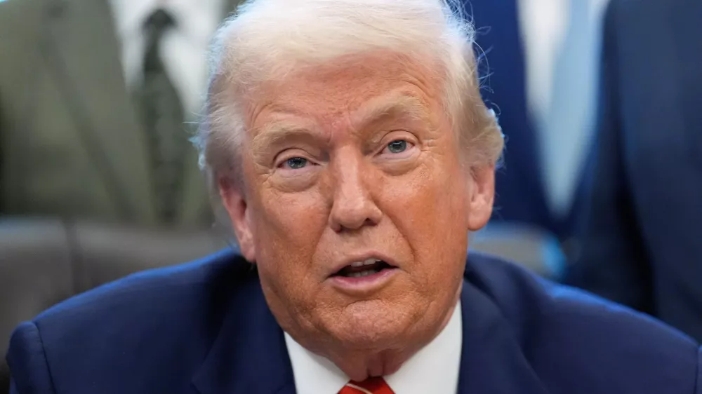 President Donald Trump speaks to reporters after signing a spending bill that ends a partial shutdown of the federal government in the Oval Office of the White House, Tuesday, Feb. 3, 2026, in Washington. (AP Photo/Alex Brandon)