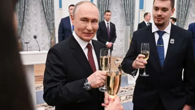 Russian President Vladimir Putin, center, toasts with participants of a ceremony to present the 2025 Presidential Prizes in Science and Innovation for Young Scientists at the Kremlin, in Moscow, Thursday, Feb. 5, 2026. (Kristina Solovyova/Sputnik, Kremlin Pool Photo via AP)