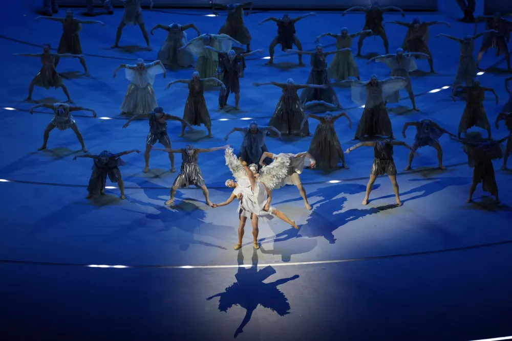 Dancers perform during the Olympic opening ceremony at the 2026 Winter Olympics, in Milan, Italy, Friday, Feb. 6, 2026. (AP Photo/Francisco Seco)