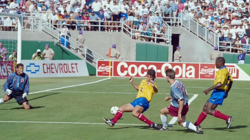 Colombian defender Andres Escobar (C) comes up short as he tries to block the shot of US forward Eric Wynalda during their World Cup match at the Rose Bowl stadium in Pasadena on June 22, 1994. The 15th FIFA World Cup took place in 1994. The United States hosted the event, which was held at nine locations nationwide from June 17 to July 17, 1994. Despite soccer's relative lack of popularity in the host country, the United States was selected, and the competition was the most profitable in World Cup history.,Image: 1046072649, License: Rights-managed, Restrictions:, Model Release: no