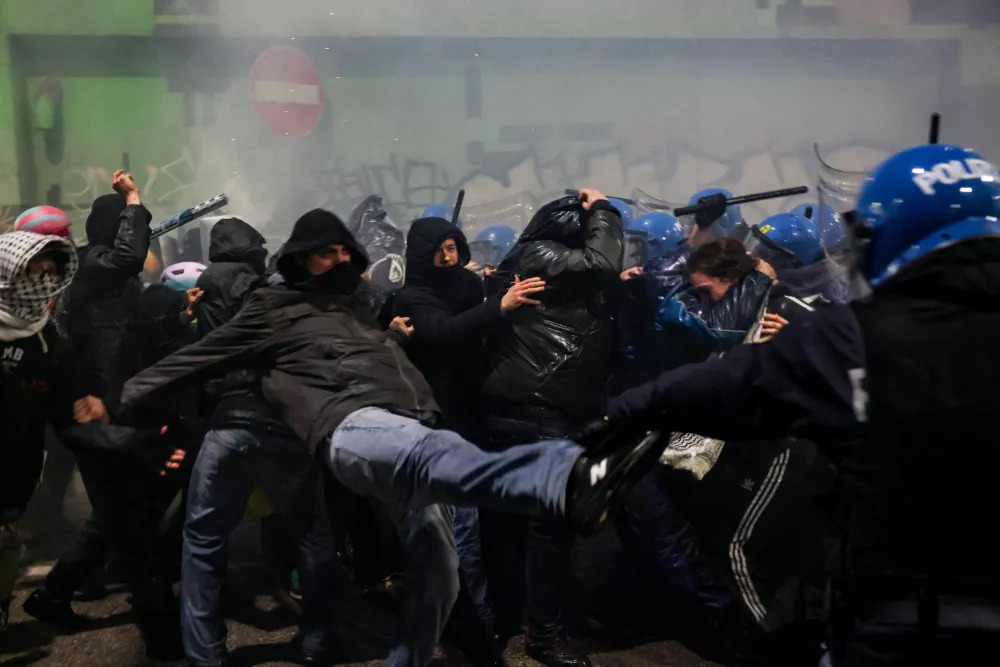 Police officers clash with demonstrators, as they were trying to block a road leading to the Santa Giulia Arena, on the day of a protest against the environmental, economic and social impact of the Milano-Cortina 2026 Winter Olympics, in Milan, Italy, February 7, 2026. REUTERS/Claudia Greco 