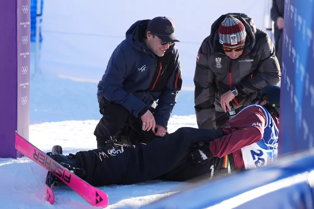 Austria's Julius Forer reacts after crashing during men's freestyle skiing slopestyle qualifications at the 2026 Winter Olympics, in Livigno, Italy, Saturday, Feb. 7, 2026. (AP Photo/Lindsey Wasson)