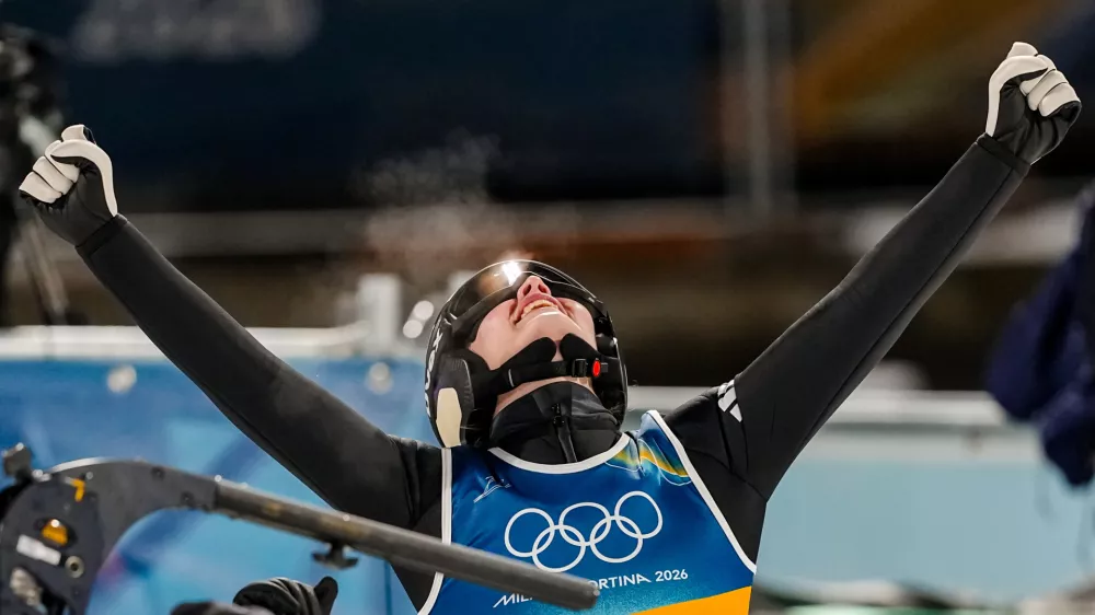 Anna Odine Stroem, of Norway, celebrates after winning the gold medal in the ski jumping women's normal hill individual, at the 2026 Winter Olympics, in Predazzo, Italy, Saturday, Feb. 7, 2026. (AP Photo/Matthias Schrader)