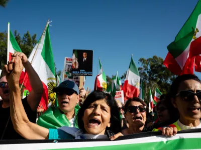 07 February 2026, US, IrvineA protester raises their fist during a Freedom for Iran rally at William R. Mason Regional Park in Irvine. PhotoGhawam Kouchaki/ZUMA Press Wire/dpa