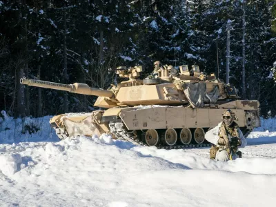 American Abrams tanks pass British soldiers from the 2nd Battalion The Royal Anglian Regiment (The Poachers) as they engage enemy troops on the Tapa range in Estonia where British soldiers are taking part in Exercise Winter Camp, which is part of Operation Cabrit, the UK's contribution to Nato's Forward Land Forces in Estonia and Poland. Picture date: Tuesday February 3, 2026.,Image: 1071924408, License: Rights-managed, Restrictions:, Model Release: no