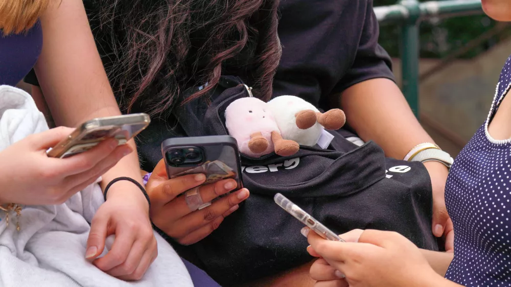 SYDNEY, AUSTRALIA - DECEMBER 10: Children use their phones, as Australia's new legislation restricting social media access for those under 16 comes into force in Sydney, Australia, on December 10, 2025. The rollout of the policy has prompted national debate over youth safety and digital regulation. Claudio Galdames Alarcon / AnadoluNo Use USA No use UK No use Canada No use France No use Japan No use Italy No use Australia No use Spain No use Belgium No use Korea No use South Africa No use Hong Kong No use New Zealand No use Turkey
