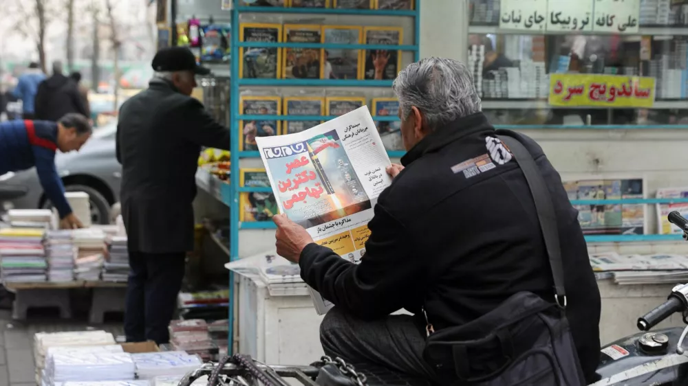 A man reads a newspaper featuring a picture of an Iranian missile, as he sits next to a bookstore, in Tehran, Iran, February 7, 2026. Majid Asgaripour/WANA (West Asia News Agency) via REUTERS ATTENTION EDITORS - THIS PICTURE WAS PROVIDED BY A THIRD PARTY   TPX IMAGES OF THE DAY