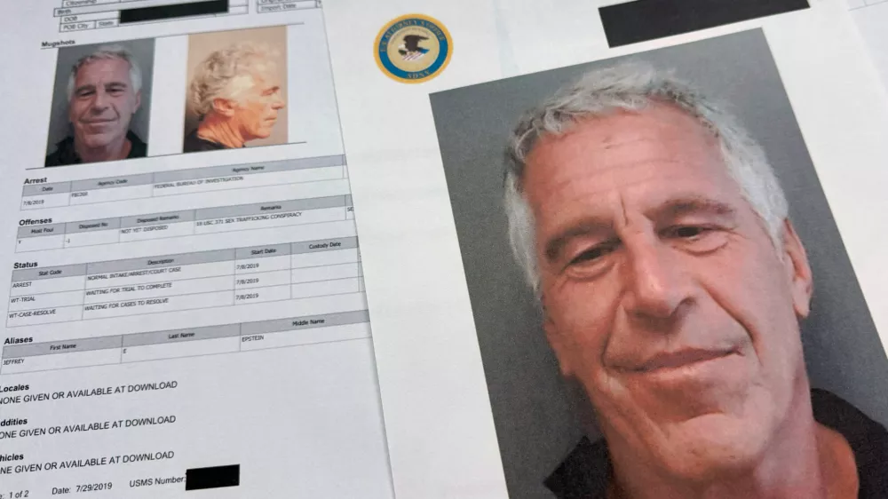 FILE - Documents that were included in the U.S. Department of Justice release of the Jeffrey Epstein files are photographed Friday, Jan. 2, 2026. (AP Photo/Jon Elswick, File)