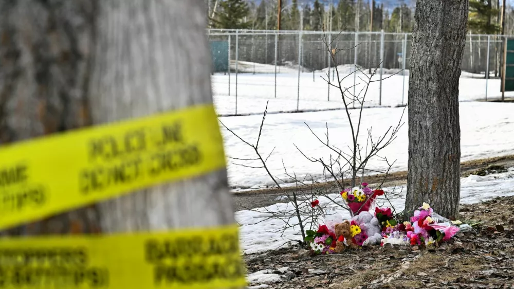 Flowers and toys lie on the ground near the site of a mass shooting at a high school, in the town of Tumbler Ridge, British Columbia, Canada February 11, 2026. REUTERS/Jennifer Gauthier REFILE - FIXING TYPO IN LOCATION