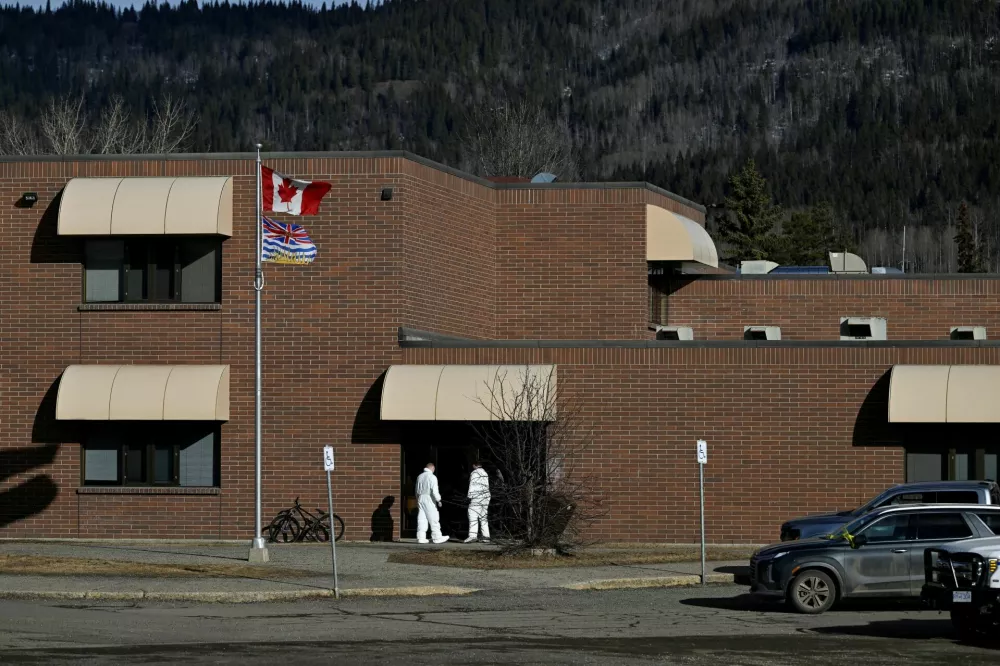 Forensic specialists get into the high school where a deadly mass shooting took place, in the town of Tumbler Ridge, British Columbia, Canada February 11, 2026. REUTERS/Jennifer Gauthier REFILE - FIXING TYPO IN LOCATION