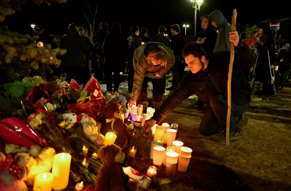 People pay tribute during a vigil, the day after a deadly mass shooting took place, in the town of Tumbler Ridge, British Columbia, Canada February 11, 2026. REUTERS/Jennifer Gauthier REFILE - FIXING TYPO IN LOCATION