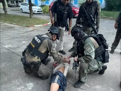 This photo released by the Royal Thai Police, shows Thai police arresting a man at Patongprathankiriwat School in Hat Yai, Songkhla province, Thailand, Wednesday, Feb. 11, 2026. (Royal Thai Police via AP)
