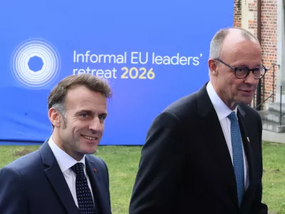 French President Emmanuel Macron, left, and Germany's Chancellor Friedrich Merz arrive for the EU summit at Alden Biesen Castle in Bilzen-Hoeselt, Belgium, Thursday, Feb. 12, 2026. (AP Photo/Francois Walschaerts)