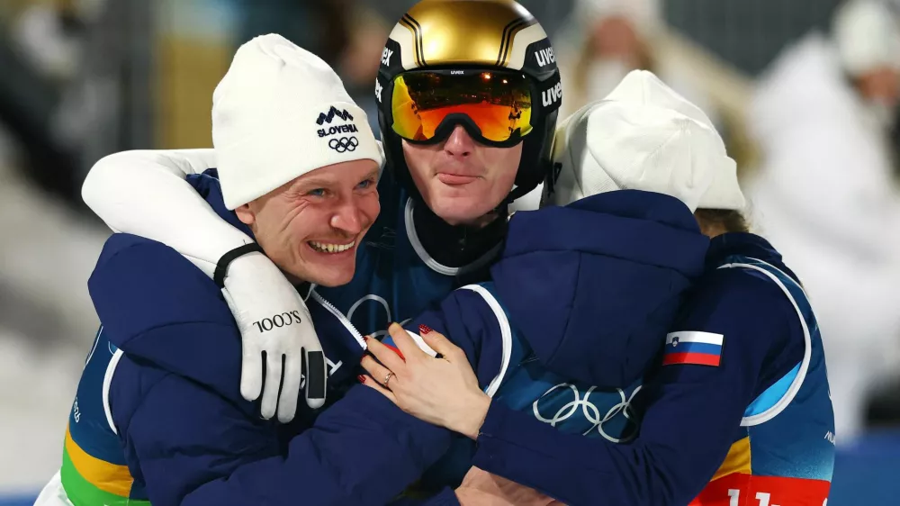 Milano Cortina 2026 Olympics - Ski Jumping - Mixed Team - Predazzo Ski Jumping Stadium, Predazzo, Italy - February 10, 2026. Nika Vodan of Slovenia, Anze Lanisek of Slovenia, Domen Prevc of Slovenia and Nika Prevc of Slovenia celebrate winning the gold medal after the final round. REUTERS/Kai Pfaffenbach