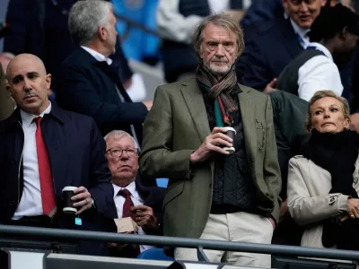 FILE - Manchester United co-owner Jim Ratcliffe stands in front of the former manager Alex Ferguson during the Premier League soccer match between Manchester City and Manchester United in Manchester, England, on Sept. 14, 2025. (AP Photo/Dave Thompson, File)