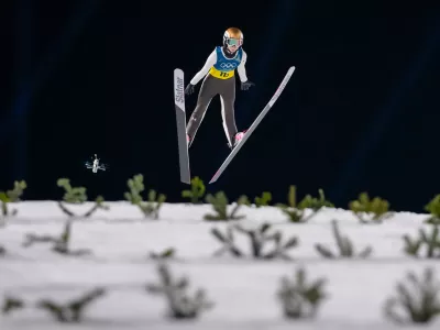 Nika Prevc, of Slovenia, soars through the air during the ski jumping mixed team competition at the 2026 Winter Olympics, in Predazzo, Italy, Tuesday, Feb. 10, 2026. (AP Photo/Kirsty Wigglesworth)