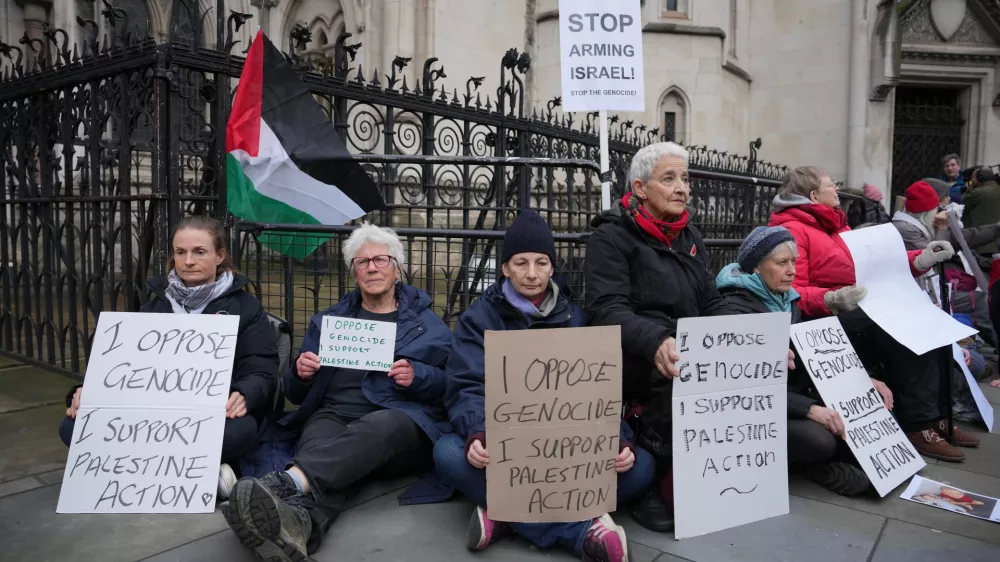 Supporters of Palestine Action stage a protest outside the Royal Court of Justice in London, Friday, Feb. 13, 2026. (AP Photo/Kin Cheung)
