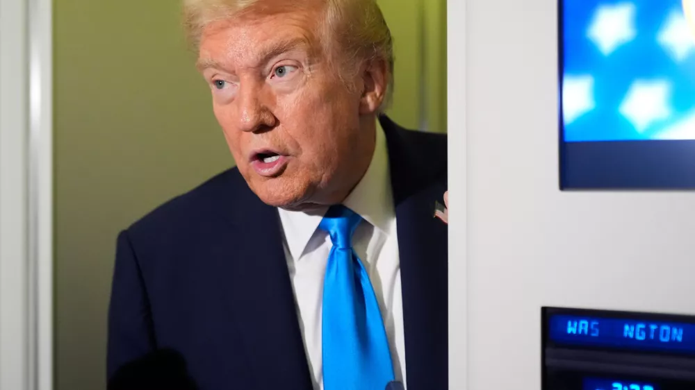 FILE - President Donald Trump speaks with reporters&nbsp;aboard Air Force One at Al Udeid Air Base in Doha, Qatar, Oct. 25, 2025. (AP Photo/Mark Schiefelbein, File)