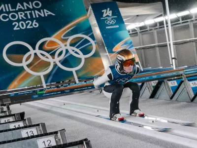 Domen Prevc, of Slovenia, goes down the ramp during his trial jump of the ski jumping men's large hill individual at the 2026 Winter Olympics, in Predazzo, Italy, Saturday, Feb. 14, 2026. (AP Photo/Evgeniy Maloletka)