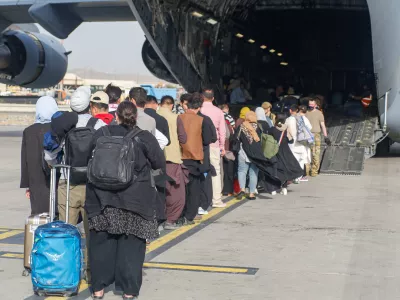 Evacuees assemble before boarding a C-17 Globemaster III during an evacuation at Hamid Karzai International Airport, Afghanistan, August 18, 2021. Picture taken August 18, 2021. U.S. Marine Corps/Lance Cpl. Nicholas Guevara/Handout via REUTERS THIS IMAGE HAS BEEN SUPPLIED BY A THIRD PARTY.