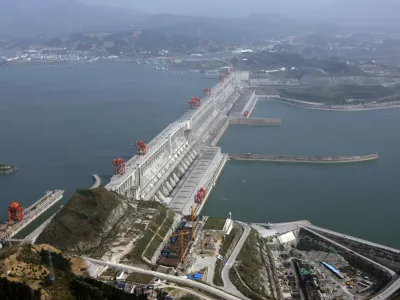 The Three Gorges Dam on the Yangtze River in Yichang, Hubei province is seen in this December 2, 2009 file photo. China's landmark Three Gorges Dam project provides benefits to the Chinese people, but has created a myriad of urgent problems from the relocation of more than a million residents to risks of geological disasters, the Chinese government said on Thursday. The statement from China's State Council, or cabinet, marked a rare acknowledgment of the issues that have shadowed the world's largest dam, an engineering feat designed to tame the Yangtze River that snakes from the Tibetan plateau to Shanghai. REUTERS/Stringer/Files (CHINA - Tags: ENVIRONMENT ENERGY BUSINESS) CHINA OUT. NO COMMERCIAL OR EDITORIAL SALES IN CHINA
